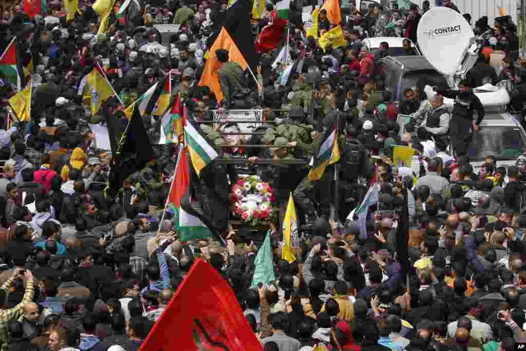 Palestinians take part in the funeral of Maysara Abu Hamdiyeh in the West Bank city of Hebron, April 4, 2013.