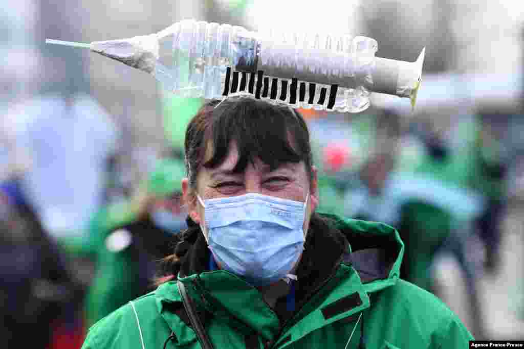 A health care worker participates in a trade union demonstration against mandatory anti-COVID19 vaccination in Brussels, Belgium.