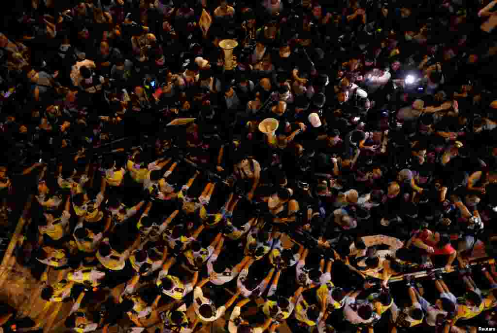 Police stop demonstrators in Hong Kong as they protest against what they call Beijing's interference over local politics and the rule of law, a day before China's parliament is expected to announce their interpretation of the Basic Law.