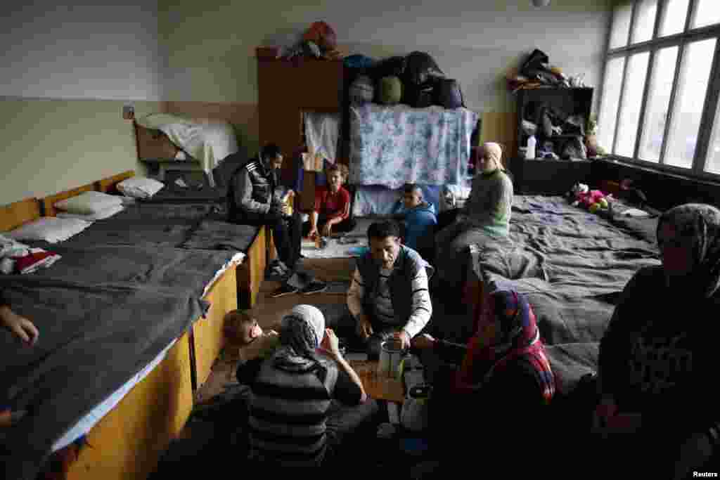 Syrian refugee have their lunch at a refugee camp as they wait for the visit of Kristalina Georgieva, EU Commissioner for International Cooperation, Humanitarian Aid and Crisis Response and Antonio Guterres, United Nations High Commissioner for Refugees, November 22, 2013.