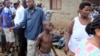 A young boy joins other onlookers at the scene where five dead bodies were found in a street in the Cibitoke neighborhood of the capital Bujumbura, Burundi, Dec. 9, 2015. 