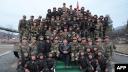김정은(앞 가운데) 북한 국무위원장이 24일 조선인민군 근위 서울류경수제105탱크사단과 산하 제1탱크장갑보병연대를 시찰하며 기념촬영하고 있다. 조선중앙통신이 다음날 공개한 사진.