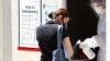 A medical staff attends to a woman as she arrives to test for coronavirus, at a hospital in Sarajevo, Bosnia and Herzegovina, 08 July 2020. 