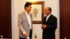 Secretary-General of Thailand's National Security Council Paradorn Pattanathabutr (L) speaks to Chairman of the Advisory Council for Peace Building in the Southern Border Provinces Aziz Benhawan, at a hotel in Kuala Lumpur March 28, 2013.
