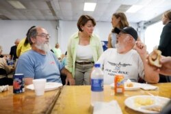 Democratic presidential candidate Sen. Amy Klobuchar talks with attendees during the Hawkeye Area Labor Council Labor Day Picnic in Cedar Rapids, Iowa, Sept. 2, 2019.