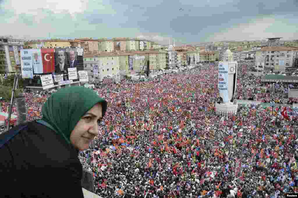 A supporter of Turkey's Prime Minister Tayyip Erdogan watches a rally organized by the ruling Justice and Development Party in Ankara, June 15, 2013.