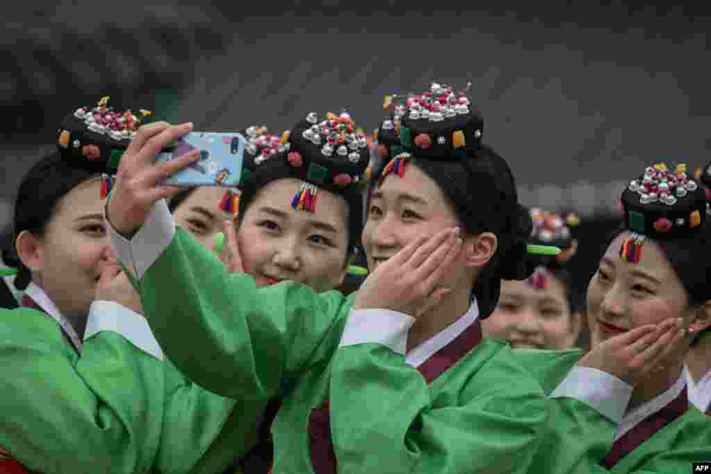Para mahasiswi Korea Selatan berfoto selfie pada perayaan tradisional memasuki 'Usia 19' di desa Namsangol, Seoul.