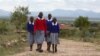 FILE - Students walk near the Imbirikani Girls High School in Imbirikani, Kenya, April 21, 2016.