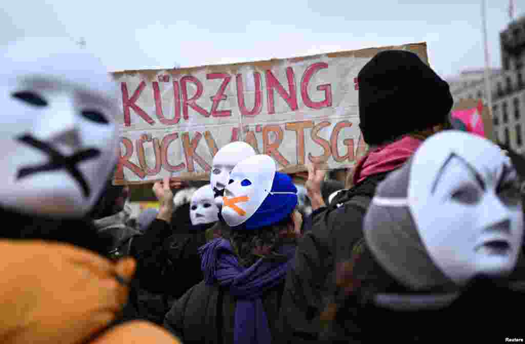 Artists and cultural workers wear masks as they attend a rally to protest under the message "Save Berlin's culture" against budget cuts in the culture sector, in front of the Brandenburg Gate in Berlin, Germany.