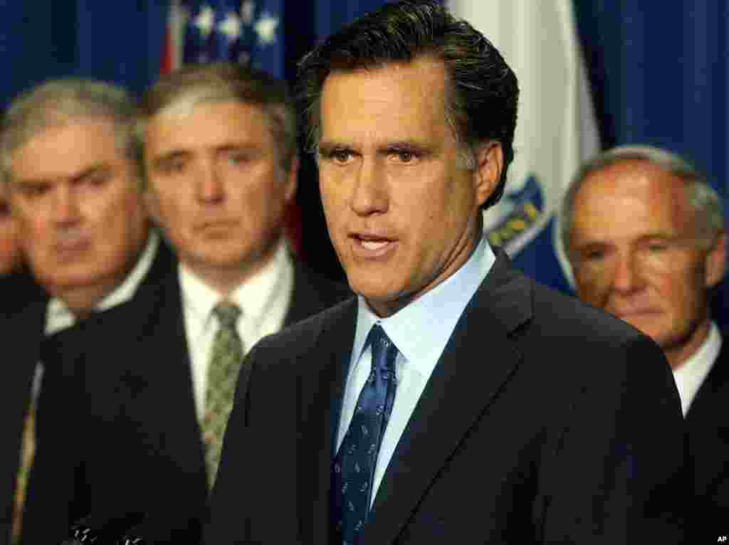 Mass. Gov. Mitt Romney, front right, proposed legislation to hike the fines for companies that spill oil or other toxic substances into Massachusetts waters, May 20, 2003.