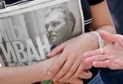 A supporter of Ivan Golunov, an investigative journalist who worked for the independent website Meduza, holds a newspaper with texts of his investigations during a protest rally in St. Petersburg, Russia, June 12, 2019.