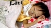 A HIV-positive girl is seen lying in a bed at the pediatric hospital in Hanoi, Vietnam, July 2010.