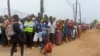 People wait for friends and relatives as a ship carrying more than 1,000 people fleeing an attack claimed by Islamic State-linked insurgents on the town of Palma, docks in Pemba, Mozambique, Apr. 1, 2021. 