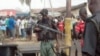 A body is seen at the site of a bomb explosion at a road in Kaduna, Nigeria, April 8, 2012.