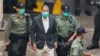 FILE - Media mogul Jimmy Lai Chee-ying, founder of Apple Daily, walks to a prison van to head to court, after being charged under the national security law, in Hong Kong, China, December 12, 2020. 