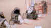 In this pool photo of a sketch by courtroom artist Janet Hamlin and reviewed by the U.S. Department of Defense, three of the five Sept. 11 defendants, from left, Ramzi Binalshibh, Walid bin Attash and the self-proclaimed terrorist mastermind Khalid Sheikh