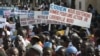 People originally from northern Mali carry signs reading 'We support army action to liberate the North,' as thousands of Malians, including elected officials, front, marched in support of foreign aid and military intervention to retake Mali's north from I