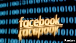 FILE PHOTO: A 3-D printed Facebook logo is seen in front of displayed binary code in this illustration picture, June 18, 2019. REUTERS/Dado Ruvic/Illustration/File Photo