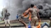 FILE - Opposition supporters burn tires and barricade roads as they fight anti-riot police at Samaria, Kisumu, Kenya, Oct. 26, 2017. 