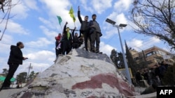 Kurdên Sûrî li Qamişlo piştî ku peykerê Beşar Esad hilweşndine nîşana serketinê bilind dikin