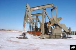 FILE - This Feb. 26, 2015, file photo, shows an oil well on the Fort Berthold Indian Reservation near Mandaree, North Dakota.