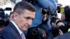 Former U.S. national security adviser Michael Flynn passes by members of the media as he departs after his sentencing was delayed at U.S. District Court in Washington, Dec. 18, 2018.