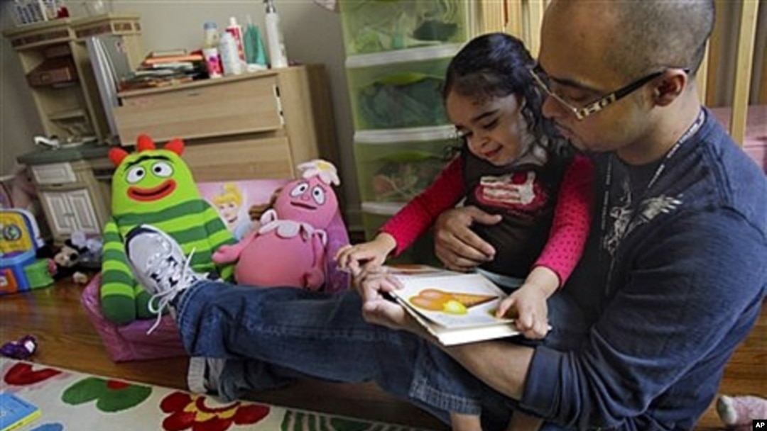 Christopher Astacio reads with his daughter Cristina, 2, who was diagnosed with a mild form of autism. A new study links induced labor with increased risk of autism.