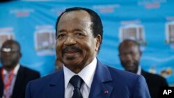 In this Oct. 7, 2018 photo, Cameroon's Incumbent President Paul Biya waits to casts his vote during the presidential elections in Yaounde, Cameroon. 