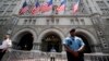 FILE - Law enforcement officers stand guard in front of the Trump Hotel in Washington, June 30, 2018.