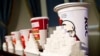 A 64-ounce drink is displayed alongside other soft drink cup sizes n New York, May 31, 2012. 