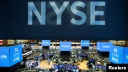 FILE - Traders work on the floor at the New York Stock Exchange, Aug. 12, 2019.