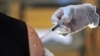 A senior adult receives a flu vaccine, Sept. 6, 2013 at the Williams YMCA in Jacksonville, Fla. 