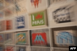 FILE - Artworks are exhibited at the "Space Invader Station" exhibition of street artist Invader in Paris, on February 27, 2024. (Photo by Thomas SAMSON / AFP) /