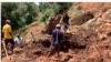 A family in Chimanimani digs, March 22, 2019, without protective clothing, for their missing 17-year-old nephew after Cyclone Idai hit the area. The body was found late Friday a week after he was trapped in his bedroom while asleep.