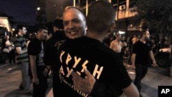 Extreme far-right Golden Dawn party's supporters celebrate and has vowed to kick out immigrants and mine Greece's borders with Turkey