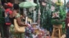 Marché central de Yaoundé, une femme négocie le prix du sapin, à Yaoundé, le 13 décembre 2018. (VOA/Emmanuel Jules Ntap)