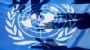 (FILES) In this file photograph taken on September 5, 2018, Palestinian school children raise the victory gesture over a UN flag during a protest at a United Nations Relief and Works Agency (UNRWA) school, financed by US aid, in the Arroub refugee camp ne