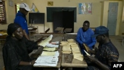Election officials count ballots cast in parliamentary elections, at a polling station in Diamalaye, a neighborhood in Dakar, Senegal, Nov. 17, 2024.