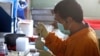 A staff member works on a blood sample of a chicken at the Veterinary Research Bureau, (File photo).