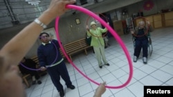 Patients with Alzheimer's and dementia are seen during a therapy session inside the Alzheimer foundation in Mexico City, FILE April 19, 2012. 