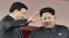 지난해 10월 북한 평양에서 열린 노동당 창건 70주년 기념식에서 김정은 국방위원회 제1위원장(오른쪽)이 중국 대표단을 이끌고 방북한 류윈산 공산당 정치국 상무위원과 함께 열병식을 참관하고 있다. (자료사진)