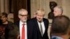 Britain's opposition Labour Party Leader Jeremy Corbyn, left, Prime Minister Boris Johnson, center right, walk through the Commons Members Lobby, during the state opening of Parliament, in London, Dec. 19, 2019.