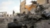 A Somali soldier observes the scene of a car bomb attack by al-Shabab in the capital Mogadishu, Somalia, June 21, 2015. 