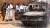 Security officers and government officials inspect a police car that was burnt during an attack on a convoy escorting the governor of Mandera region Ali Roba outside Mandera town, near Kenya's border with Somalia and Ethiopia, March 13, 2015. 